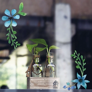 Detail of clear glass hydroponic vases with twine decor and HOME wood tray stand