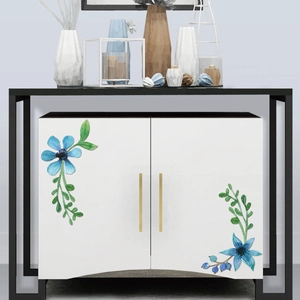 Blue watercolor floral stickers on white cabinet doors with gold handles