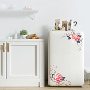 Detail view of pink rose floral decals on a white refrigerator with elegant vine accents