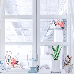 Detail of red rose floral wall stickers applied to a window for home decoration