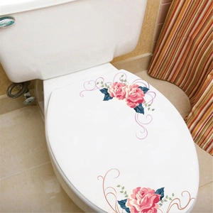 Detailed view of pink rose floral stickers applied on a white ceramic toilet lid cover