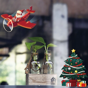 Macro detail of Christmas wall stickers featuring Santa and tree on glass and wooden boxes