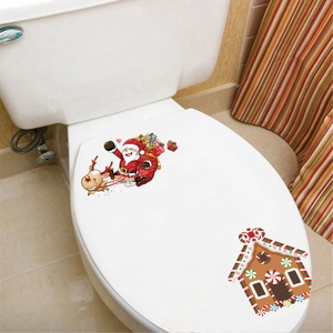 Detail of Christmas Santa and reindeer stickers on a white toilet lid in bathroom