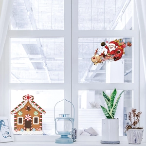 Christmas window stickers set featuring gingerbread house and Santa Claus on glass surface