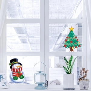 Detailed Christmas window decals showing a cute snowman and decorated tree on a glass surface