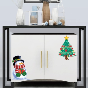 Detailed view of Christmas snowman and festive tree decals applied to white cabinet doors