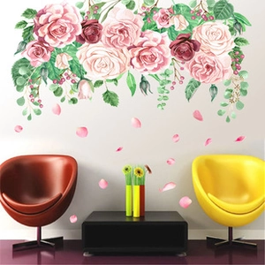 Detailed watercolor pink rose wall stickers with green leaves on a white living room wall