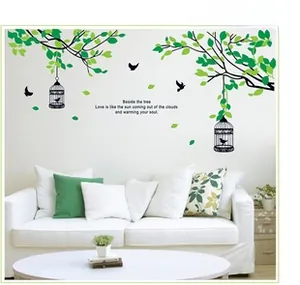 Living room wall decal featuring green leaves, birdcages, and poetic birds mural