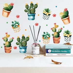 Detail of watercolor cactus wall decals in a stylish living room setting with decor