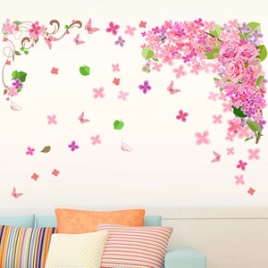 Detailed view of pink rose and butterfly wall stickers applied on a living room wall
