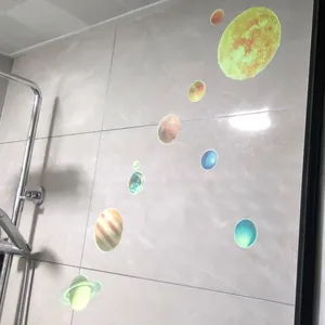 Detailed view of luminous solar system planet wall stickers on a smooth surface