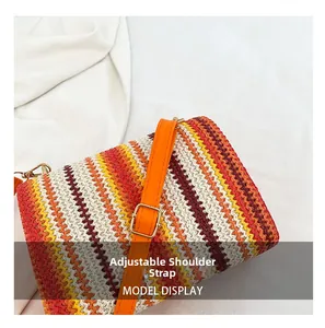 Detail of bohemian woven bag featuring an adjustable orange leather shoulder strap