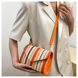 Detail of colorful woven shoulder bag with wavy red, orange, and yellow stripe pattern