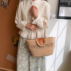 Straw woven tote bag with colorful dots and pearl closure for summer beach vacation