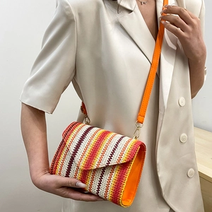 Ethnic style woven crossbody bag with colorful wavy patterns and orange shoulder strap