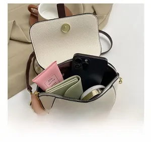 Internal view of minimalist square crossbody bag showing daily essentials capacity