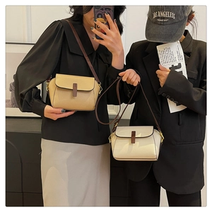 Close-up of minimalist square crossbody bags featuring contrast texture and flap closure