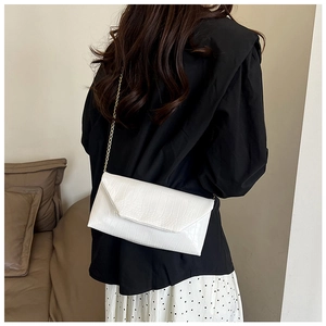 White faux crocodile leather envelope crossbody bag with a delicate gold chain strap