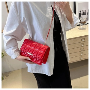 Détails du sac bandoulière matelassé rouge avec boucle dorée et bandoulière chaîne