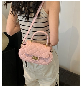 Pink quilted crossbody bag with golden rotary lock shown on model for daily lifestyle wear