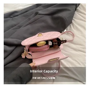 Detailed interior capacity view of pink baguette bag showing storage for cosmetics