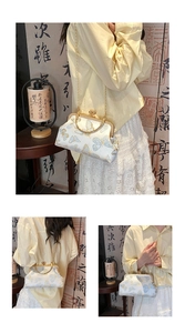 Detailed close-up of white Chinese style bag featuring blue and gold butterfly embroidery