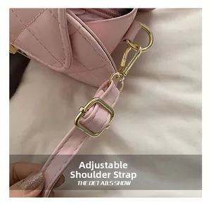 Detail of adjustable pink quilted leather shoulder strap with gold hardware buckle
