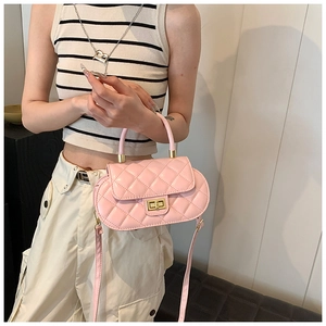Detail of pink quilted baguette bag with gold lock and sleek rounded silhouette