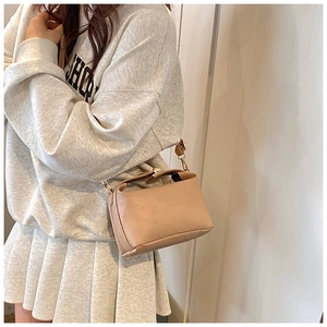 Detailed close-up of apricot PU leather bag with rich rabbit embossed pattern and chain