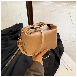 Detail of rich rabbit embossed leather texture on vintage camel crossbody bag