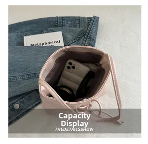 Internal view of pink bucket bag showing storage space for phone and sunglasses