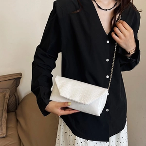 Elegant white crocodile-embossed envelope bag with a thin gold chain strap for women