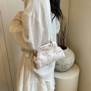 Elegant ivory satin kiss-lock handbag with butterfly embroidery and golden handle