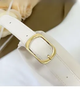 Detail showing the adjustable golden metal buckle and white leather strap of the shoulder bag
