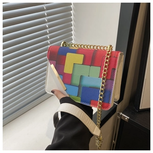 Detail of color-block Tetris-inspired geometric pattern on a faux leather crossbody bag
