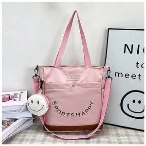 Borsa tote rosa con tracolla e piccolo portamonete bianco a forma di faccina sorridente