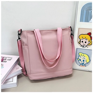 Sac fourre-tout en toile rose avec poche latérale, bandoulière réglable et grand espace