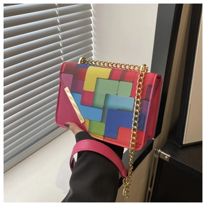 Detail of colorful geometric square patterns and gold chain on the mini crossbody bag