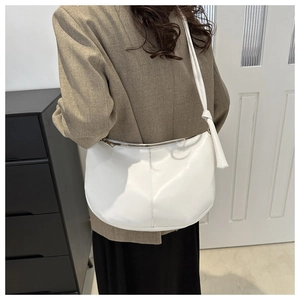 Detailed side view of white PU leather hobo shoulder bag with zipper and stitching details