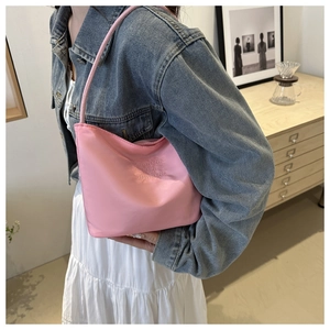 Detail of pink nylon shoulder bag with onwards and upwards embroidery on glossy fabric