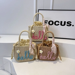 Straw woven handbags with hello embroidery, floral accents, and decorative scarves