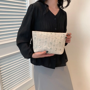 Chic cream woven crossbody bag with green floral embroidery and zipper for summer style