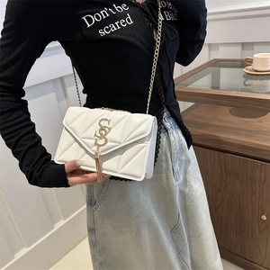White quilted crossbody bag with gold S-logo fringe and elegant chain strap for women
