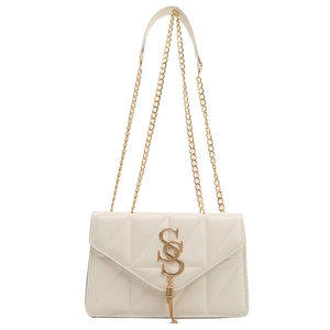 Minimalist cream white quilted crossbody bag with gold chain strap and stylish S-shaped logo