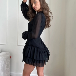 Elegant black chiffon A-line dress with lace collar and tiered ruffles in a French style