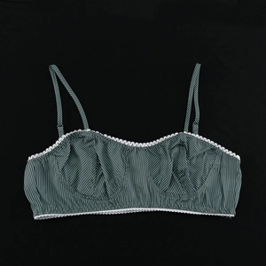 Detail of dark green striped camisole top with delicate white lace trim and thin straps