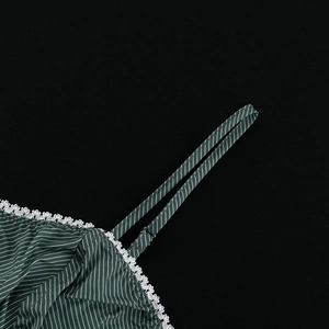 Close-up of green striped camisole featuring delicate white lace trim and fabric straps