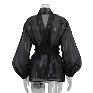 Rear view detail of black sheer mesh blouse showing tie-waist wrap and elastic cuffs