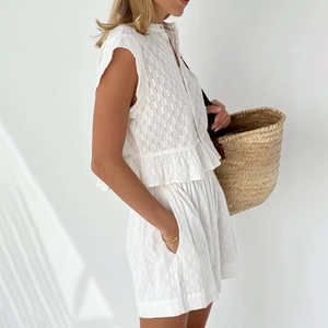 Detailed texture of white jacquard summer set with sleeveless top and wide-leg shorts