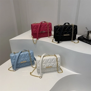 Chic quilted chain bags in magenta black sky blue and white on a display stand